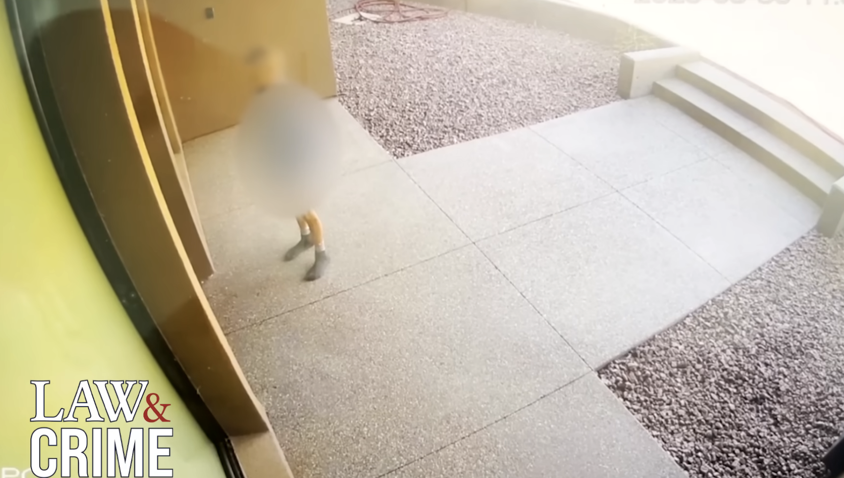 Surveillance footage showing a blurred child outside a building