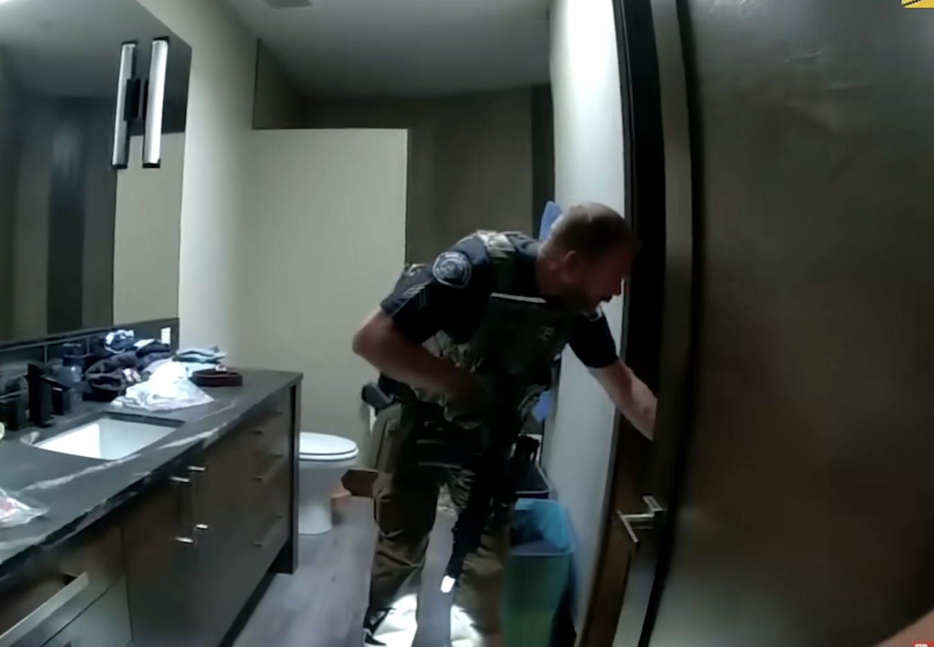 A law enforcement officer searching a bathroom