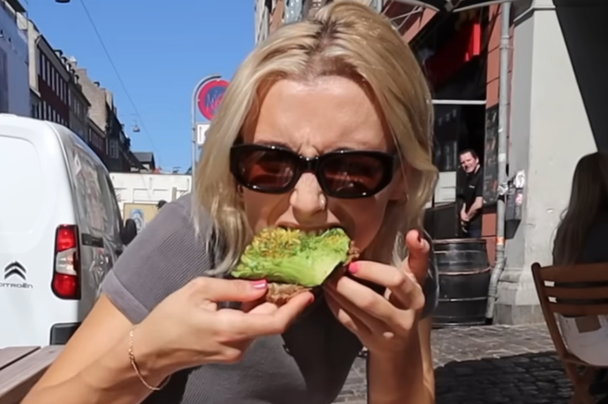 Emma Chamberlain eating avocado toast outside