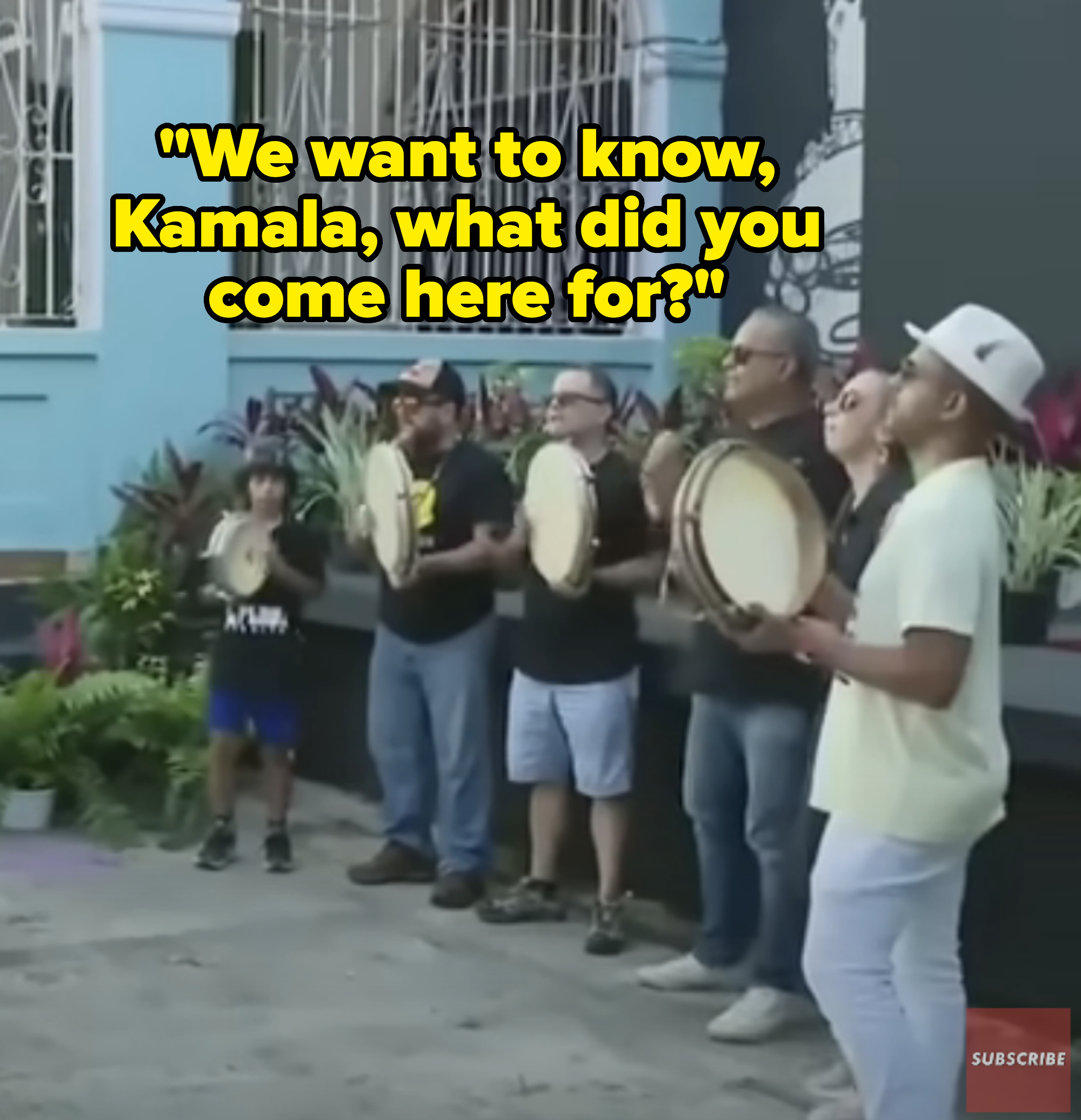 Group of people playing tambourines on a street