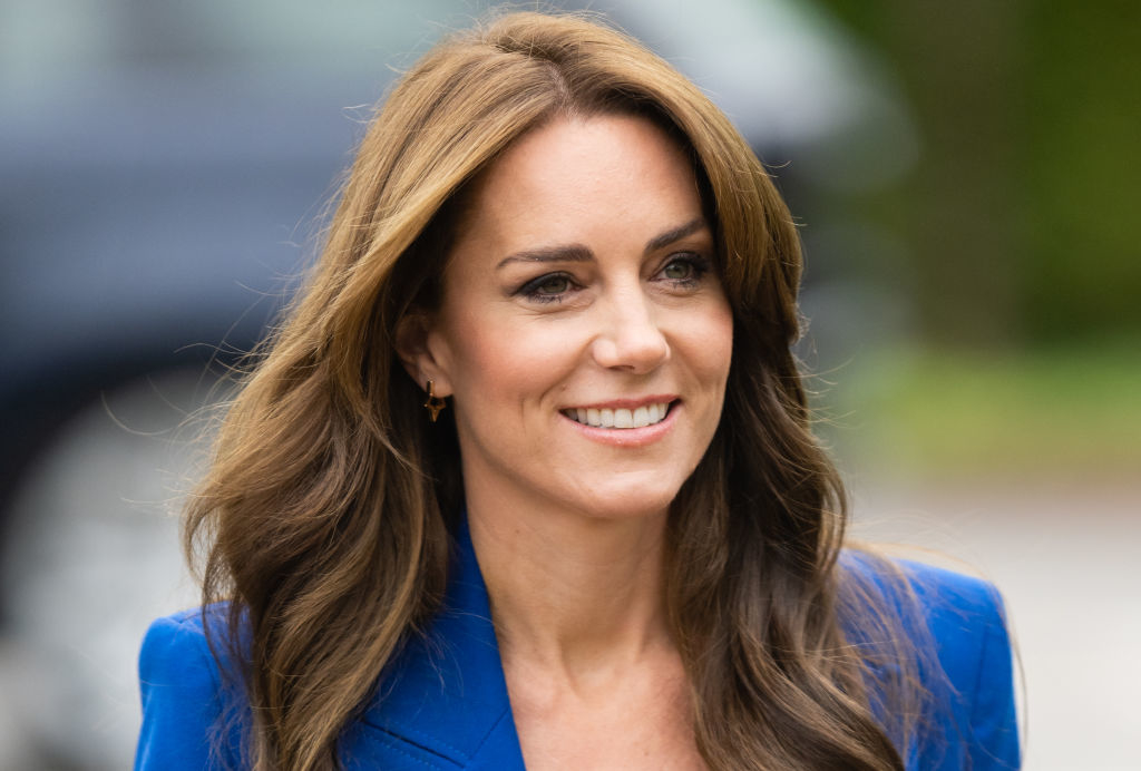 Kate Middleton smiling in a professional blue blazer