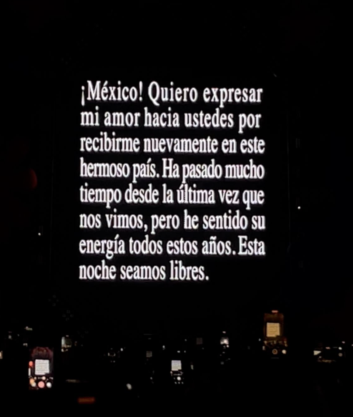 Mensaje en pantalla durante concierto expresando amor y gratitud hacia México y deseos de libertad en la noche