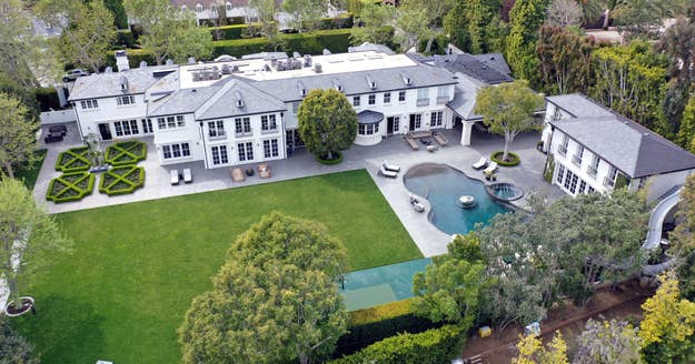 Aerial view of a sprawling luxury estate with manicured lawns and a pool, linked to an article about music celebrities' homes
