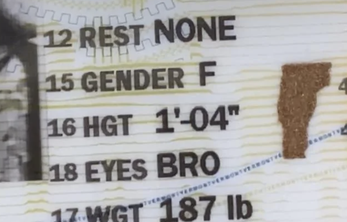 Close-up of a document with personal details, including gender marked as &#x27;F&#x27;, height &#x27;1-04&#x27;, and eye color &#x27;BRO&#x27;