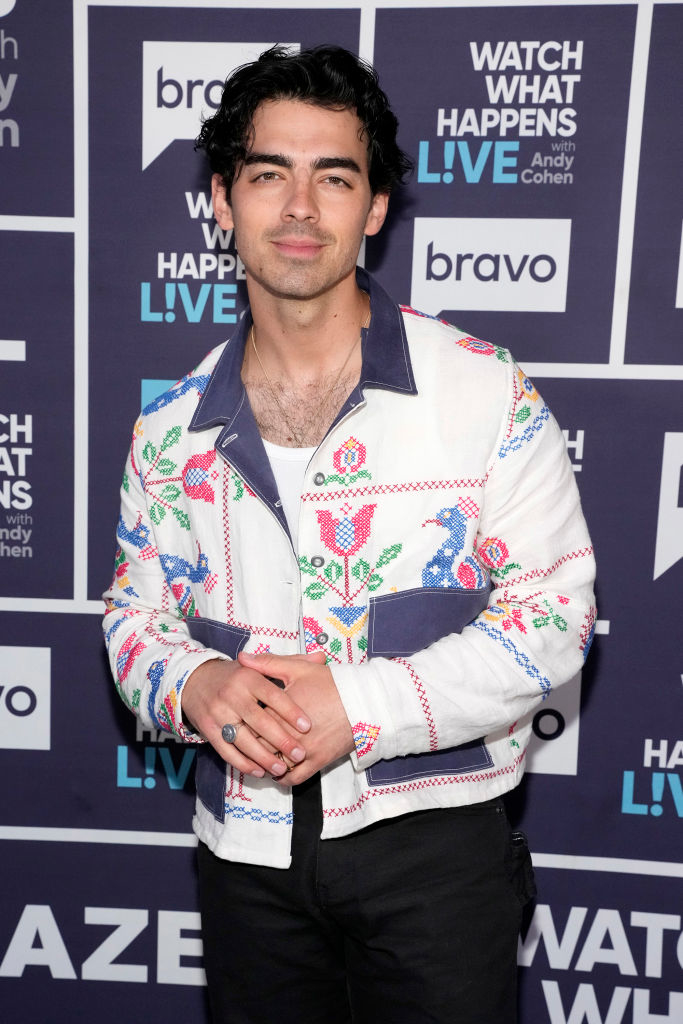 closeup of him in a patterned jacket at an event