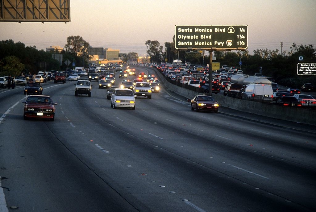 Traffic on a highway with overhead signs for Santa Monica Blvd and Olympic Blvd