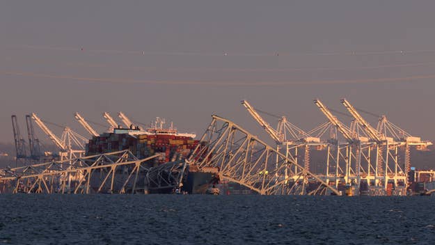 Cargo ship and bridge at a port during dusk