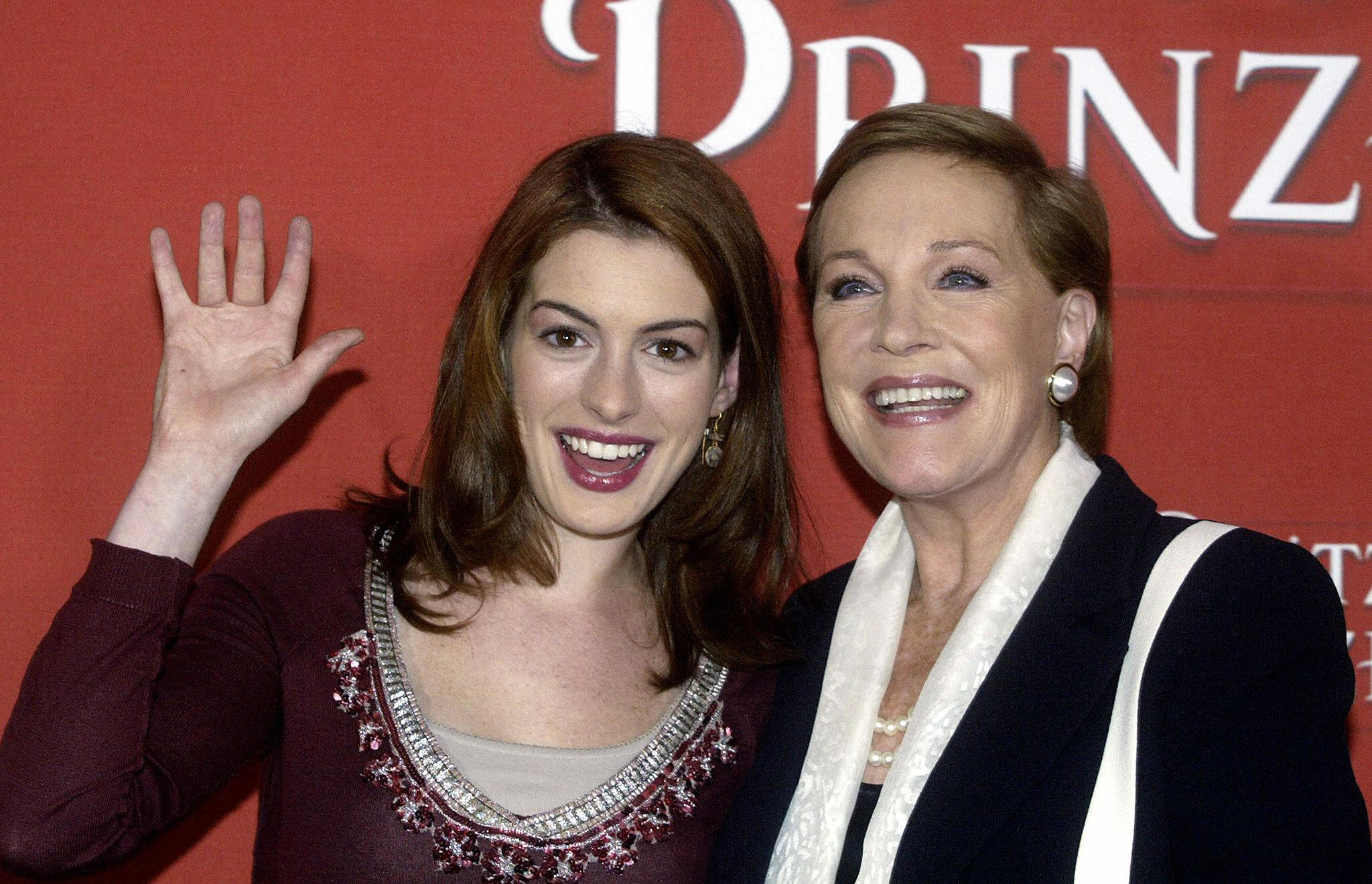 anne waving and standing next to julie andrews