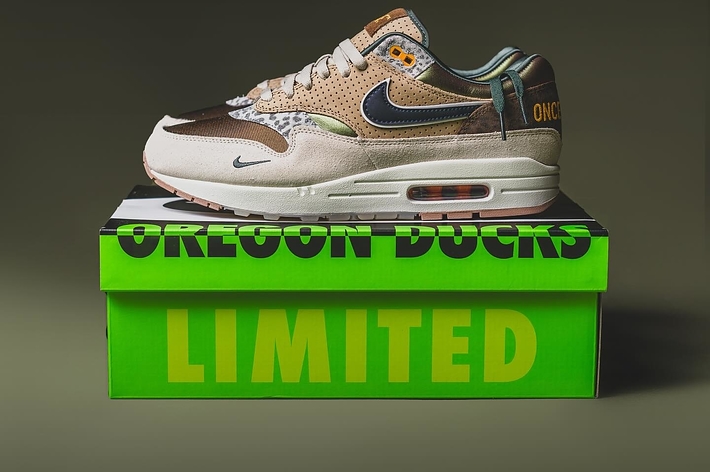 Nike sneaker on a green "OREGON DUCKS LIMITED" box, featuring sports team logos and unique design details