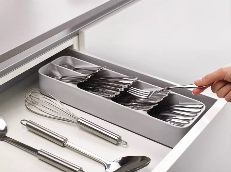 The cutlery organizer in use in a drawer