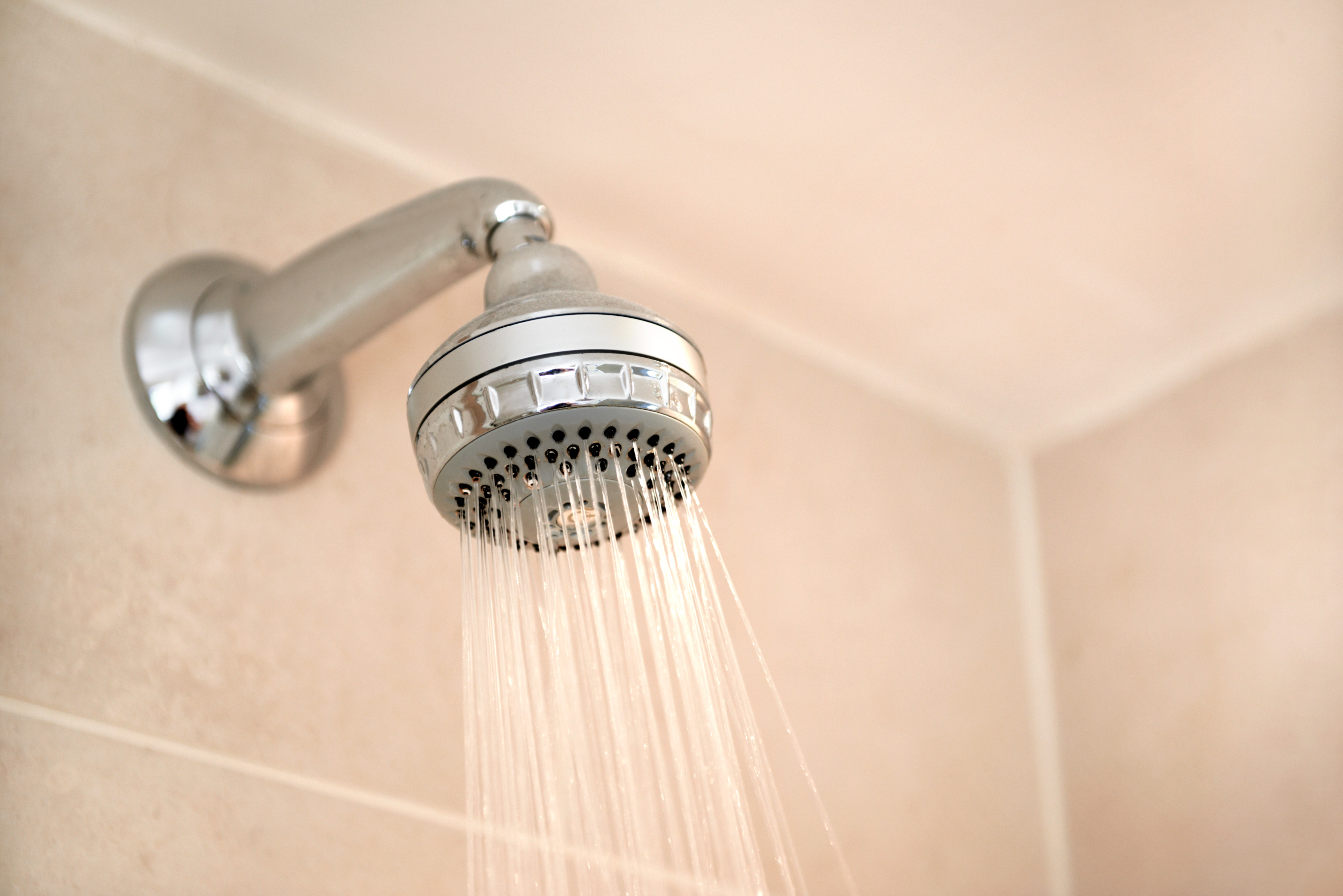 Water flowing from a showerhead in a bathroom