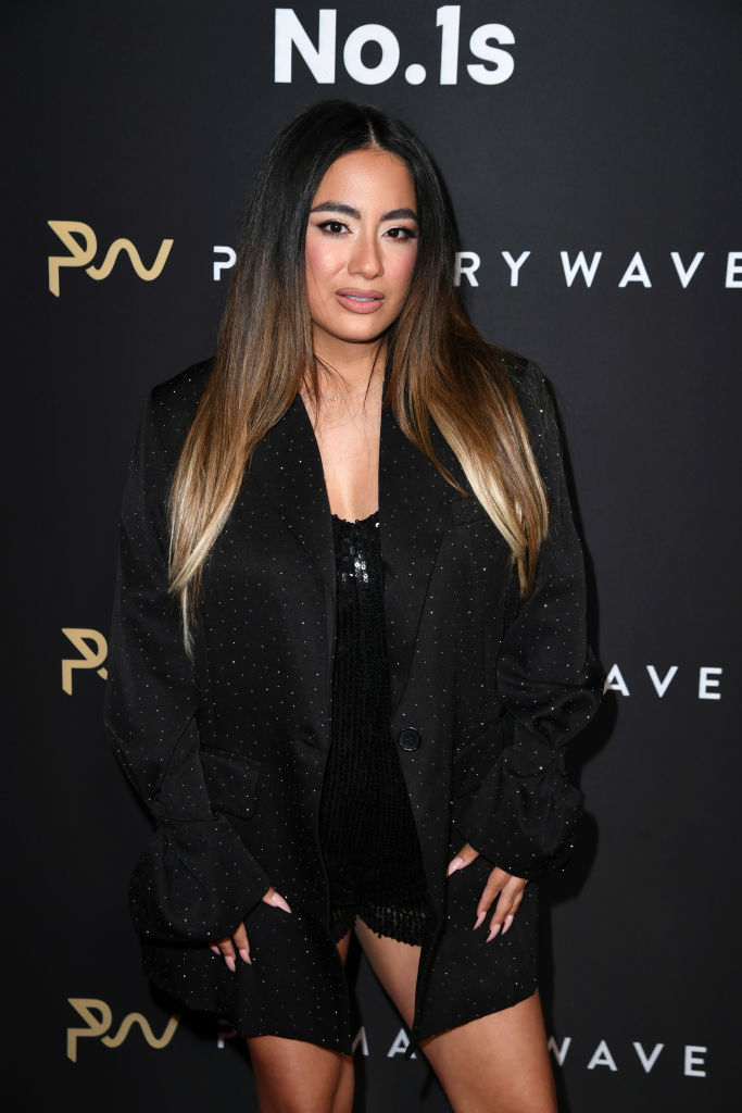 Ally in a dotted blazer dress poses at a PrettyLittleThing event