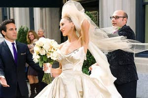 Carrie Bradshaw wearing an elaborate wedding dress and holding a rose bouquet in the Sex and the City movie