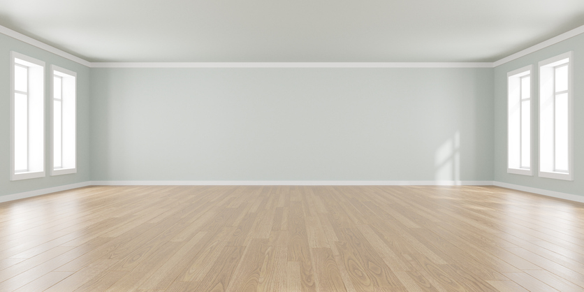 Empty room with bare walls, hardwood floors, and multiple windows