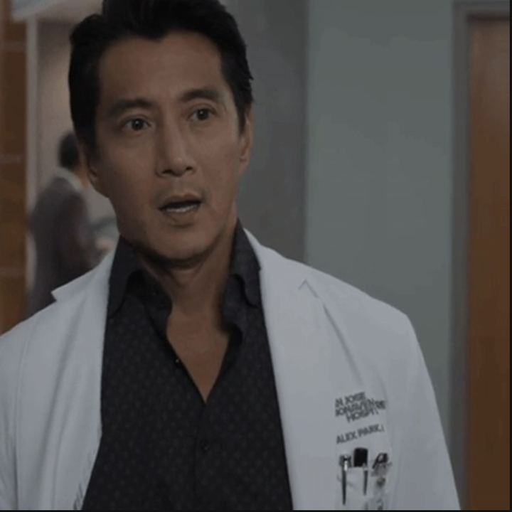 Alex Park in white lab coat, patterned shirt, in a hospital scene from "The Good Doctor"