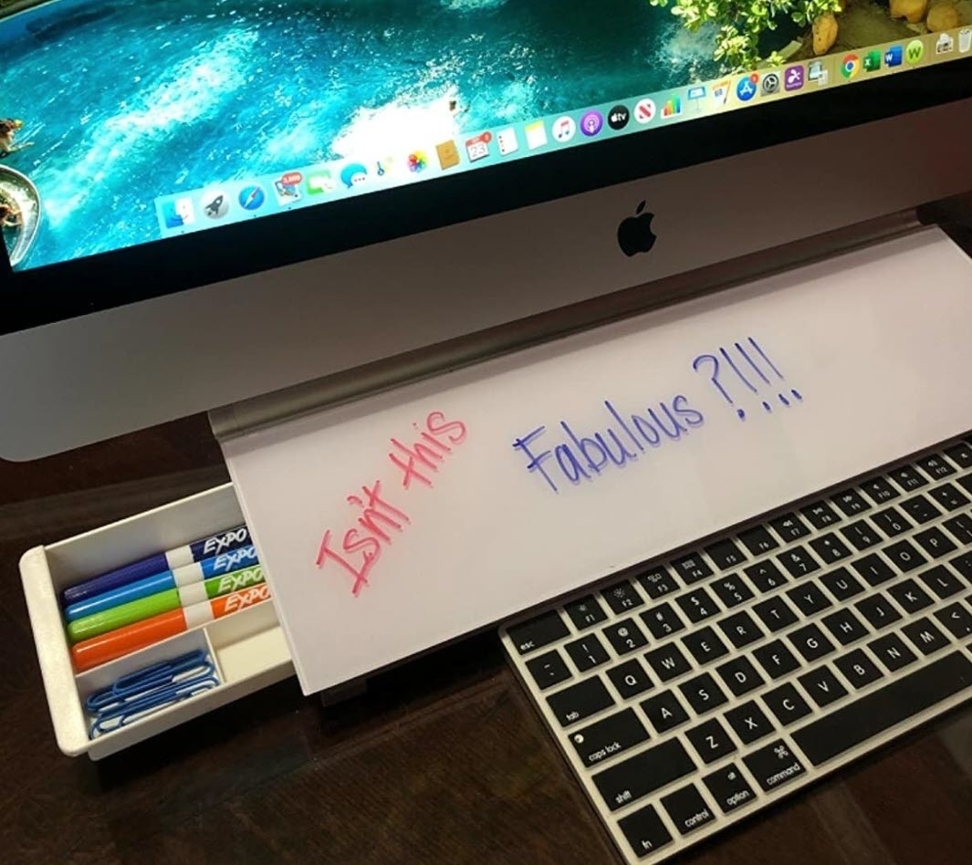 Handwritten notes &quot;Isn&#x27;t this&quot; and &quot;Fabulous?!!&quot; with markers on a desk, beside a keyboard and monitor