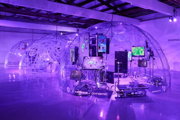 Transparent domes with electronic displays and futuristic sneakers at an exhibition