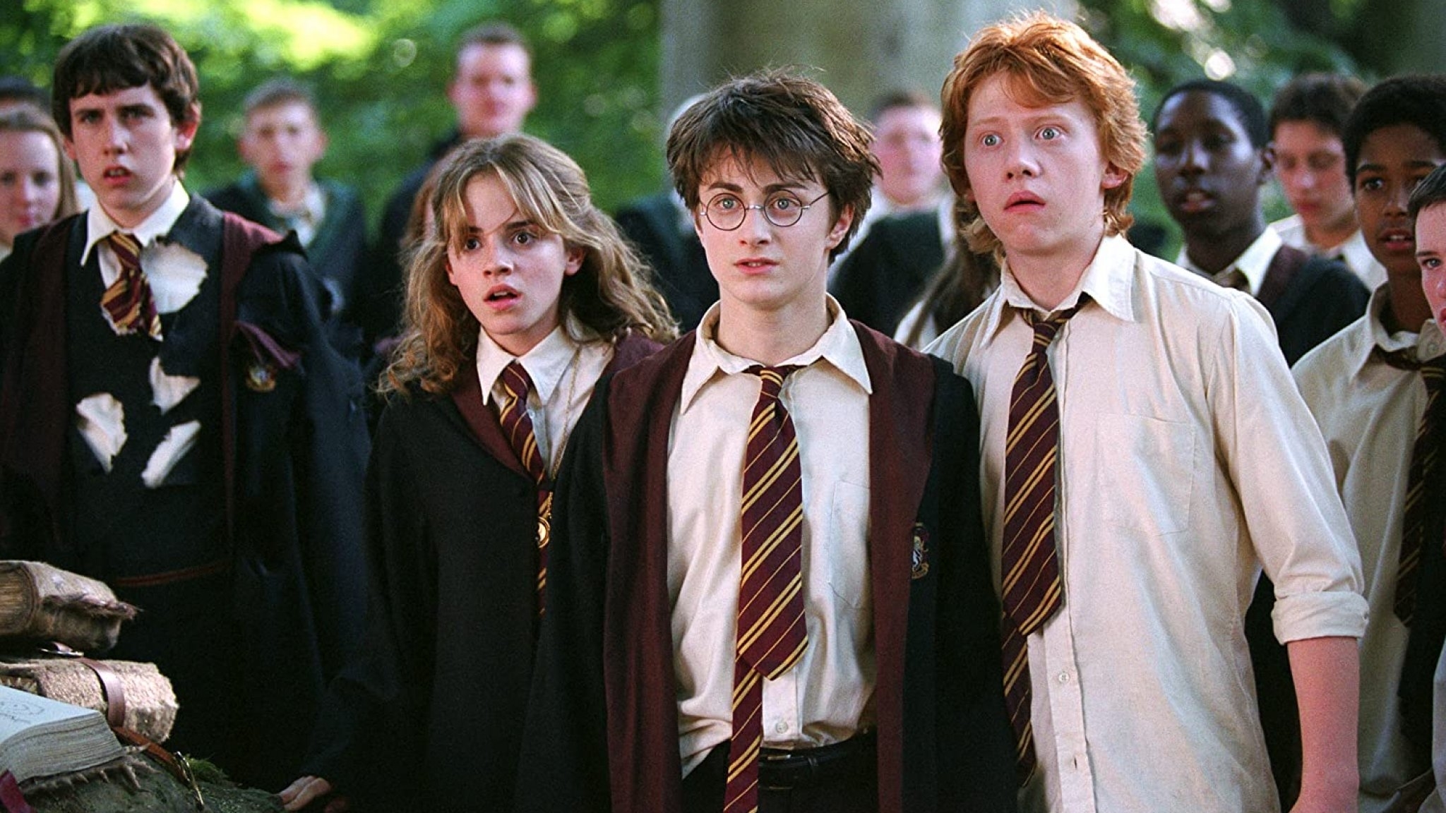 Hermione, Harry, and Ron from &quot;Harry Potter&quot; in school uniforms, looking surprised