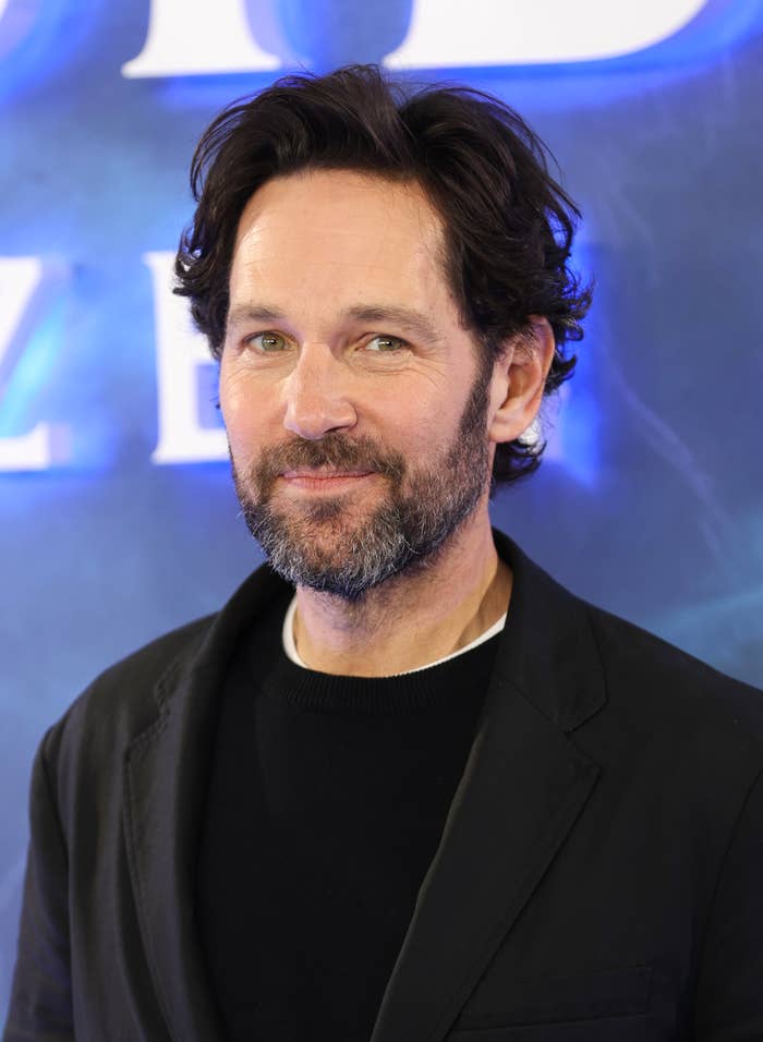 Paul Rudd at an event wearing a black suit and a casual black shirt