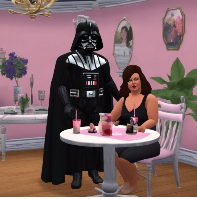 Darth Vader and a woman sitting at a table with drinks, in a pink room with portraits on the wall
