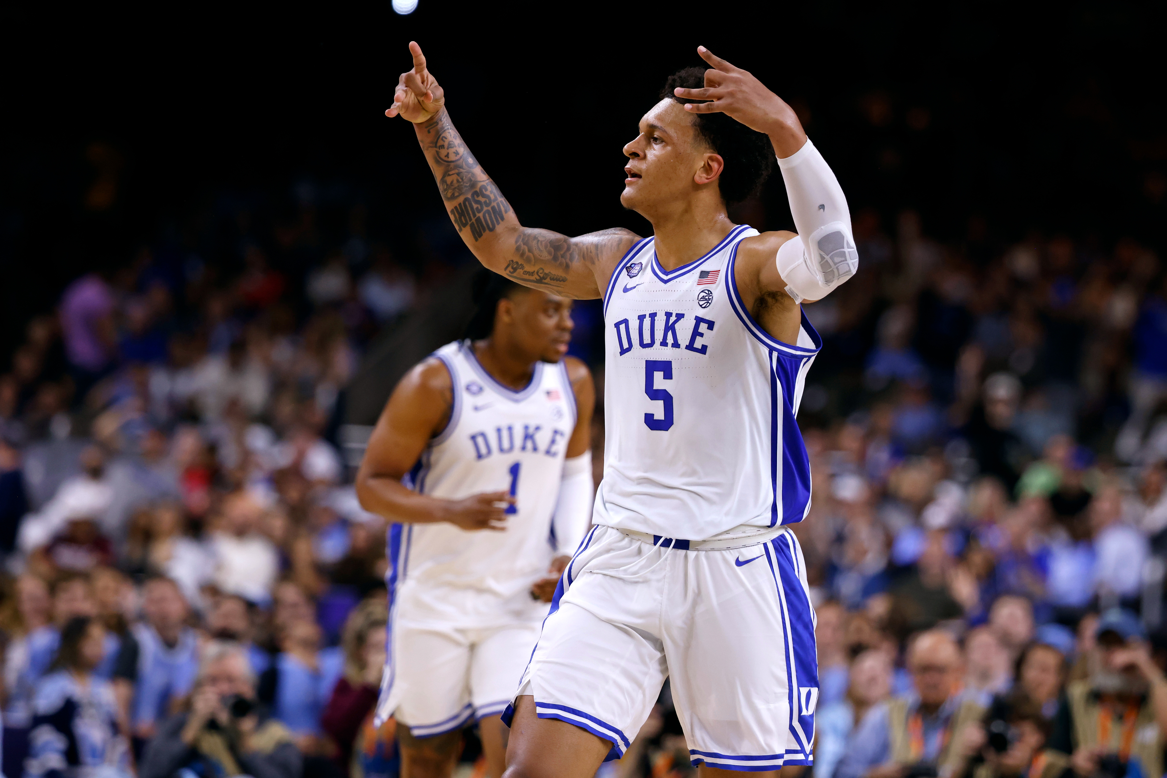 Duke basketball player #5 gestures triumphantly on the court during a game