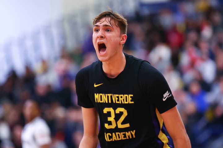 Athlete in Montverde Academy basketball uniform exclaims during game