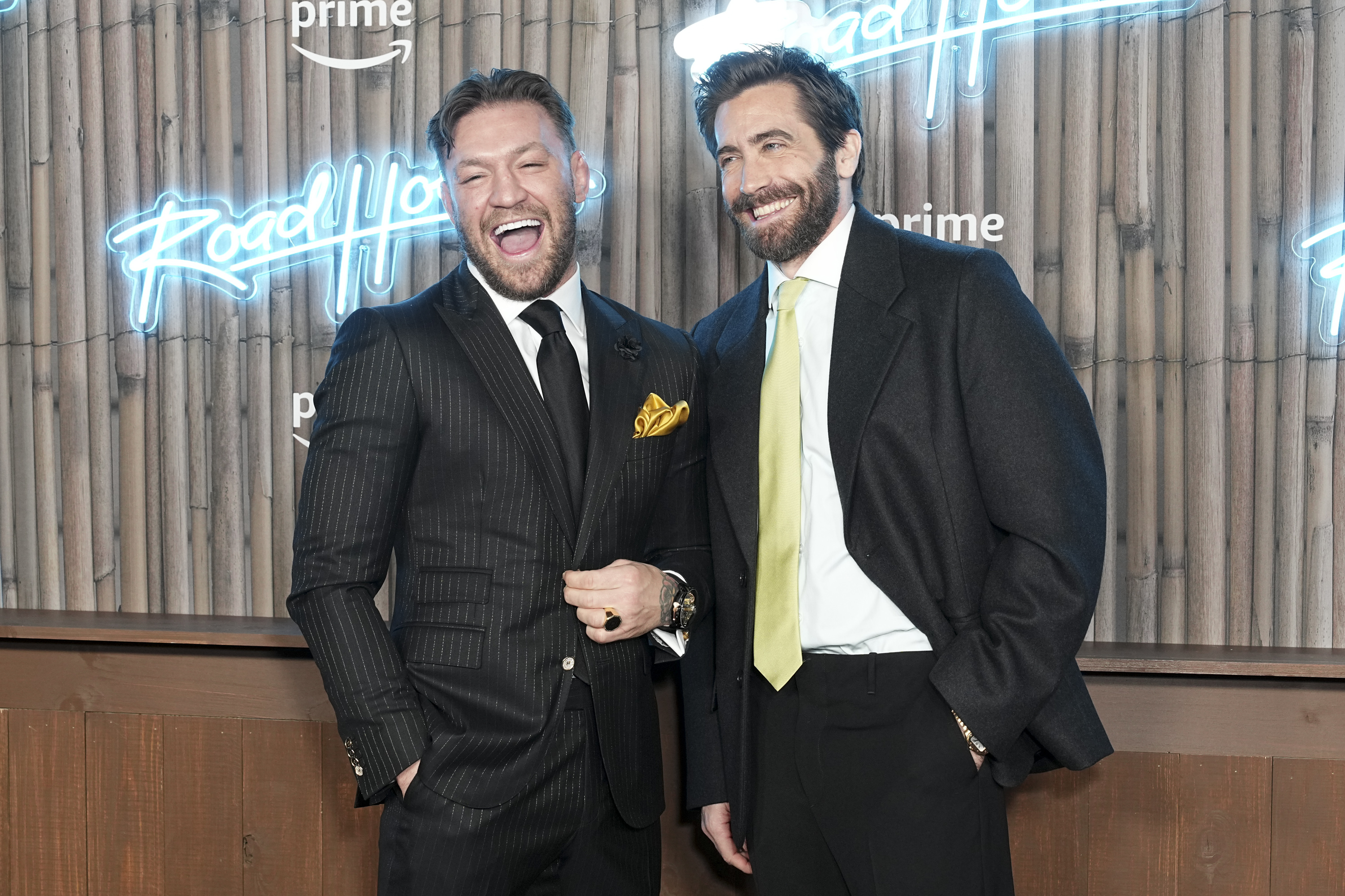 jake and connor laughing, dressed in suits at the premiere