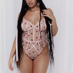 Model in a lingerie bodysuit with bow details