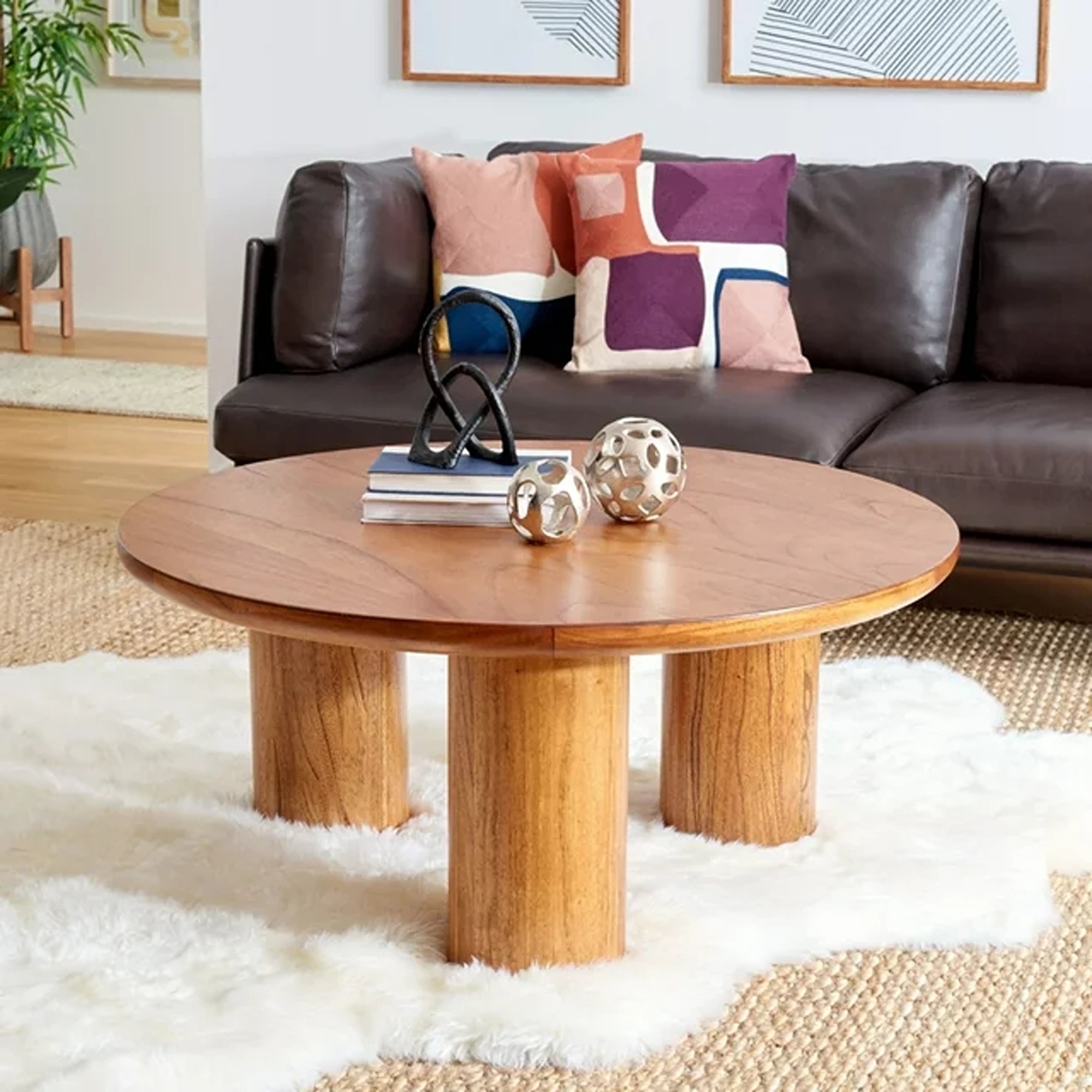 Wooden coffee table with decorative items and a fluffy white rug in a cozy living room setting