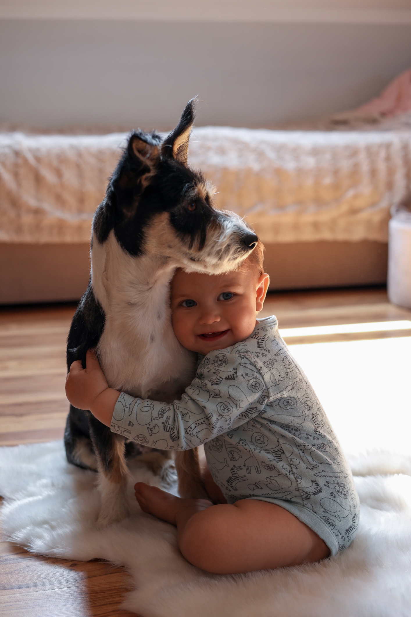 Toddler embracing a small goat indoors, conveying a sense of childhood animal bonding