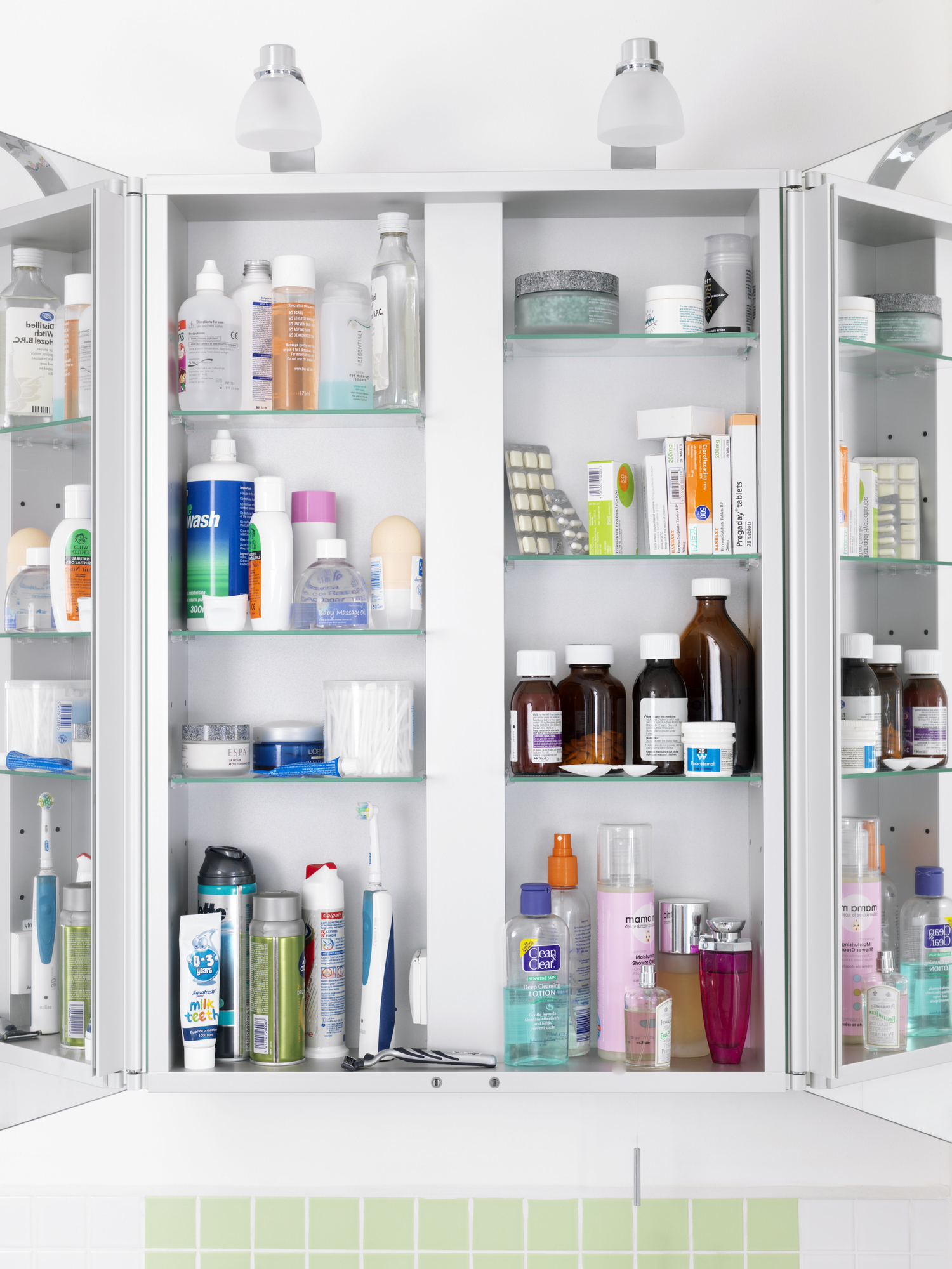 A medicine cabinet open displaying various personal care products and medications neatly arranged on shelves