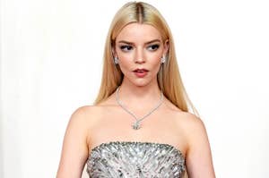 Anya Taylor Joy looking off to the side while wearing a sparkling gown with necklace and earrings