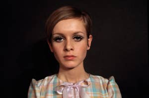 Headshot of Twiggy with a bow-tie blouse, iconic 60s makeup, looking at the camera