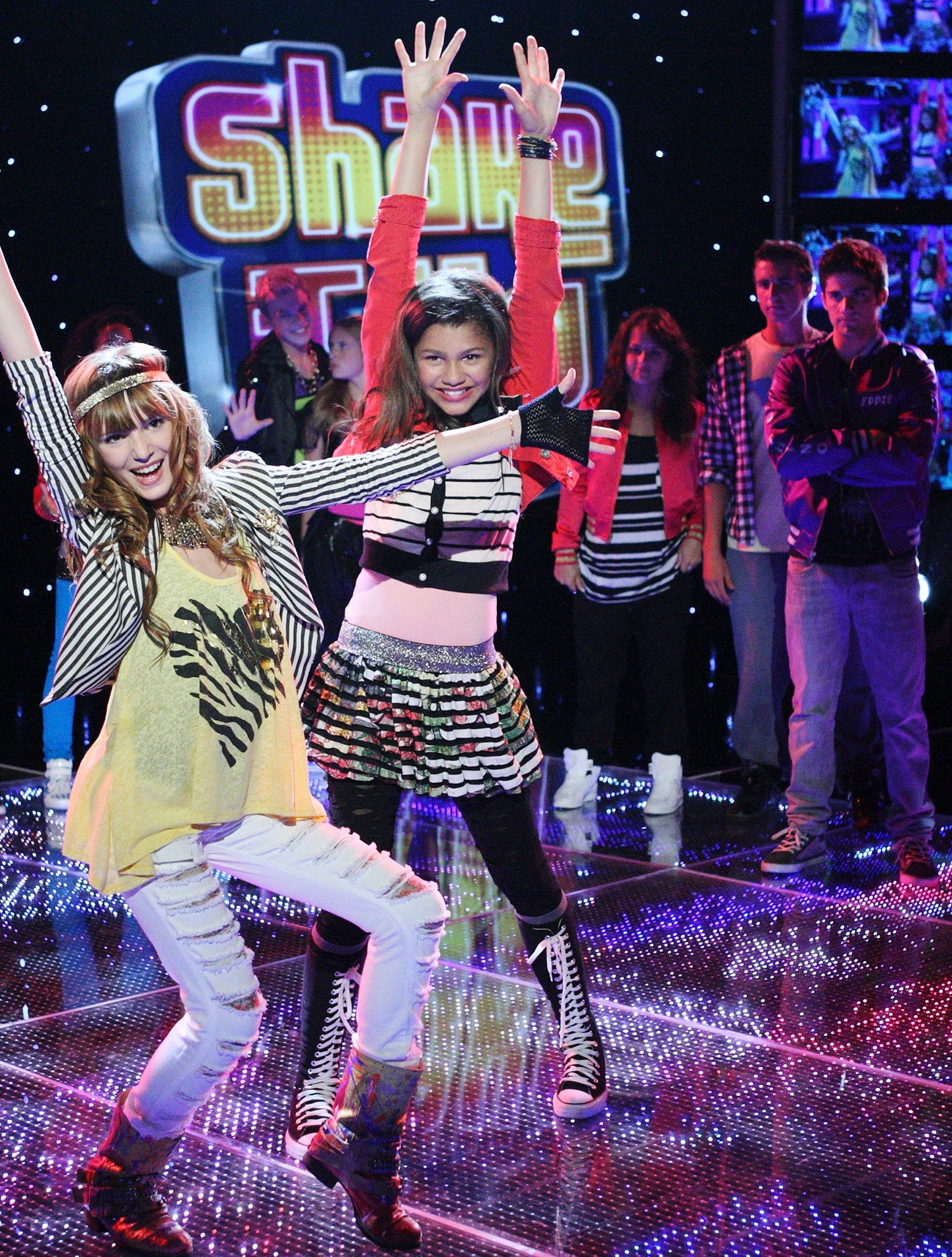 CeCe and Rocky from the TV show &quot;Shake It Up&quot; are dancing on stage with extras in the background