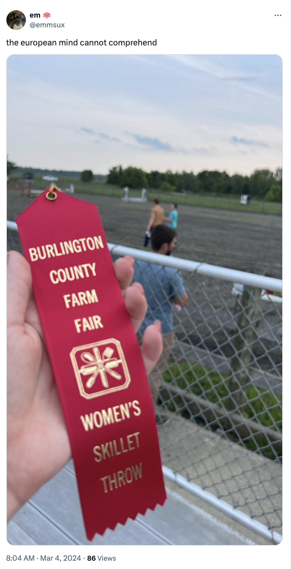 Person holding a red ribbon award for Women&#x27;s Skillet Throw at the Burlington County Farm Fair