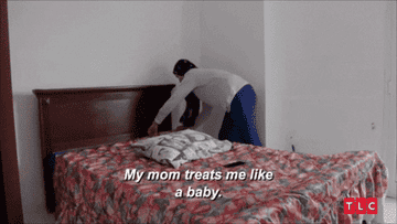 Person making a bed with text overlay &quot;My mom treats me like a baby.&quot;