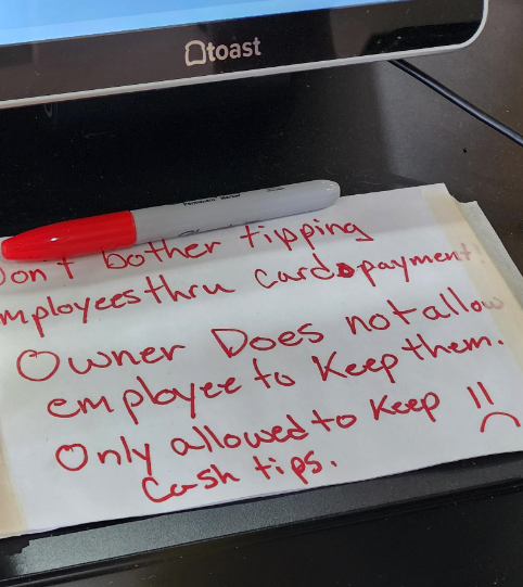 Note on paper saying employees can&#x27;t keep credit card tips, only cash, with a sad face