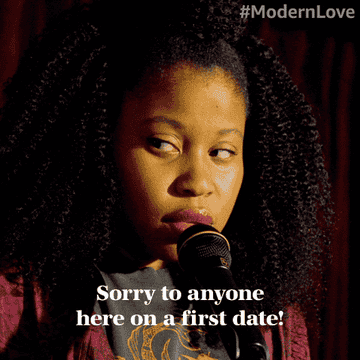 Woman onstage speaking into a microphone with text "Sorry to anyone here on a first date!"
