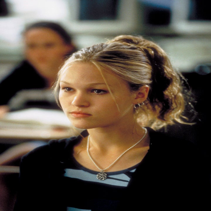 Julia Stiles as Kat Stratford in a scene wearing a black outfit with a pendant necklace