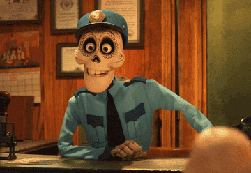 Animated character, a skeleton in a police uniform, from the movie Coco, sitting at a desk with jaw dropping