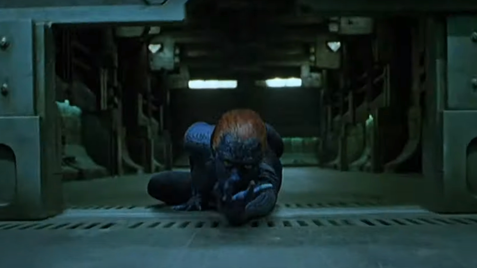 Mystique in human form, crouched, in a dimly lit industrial space