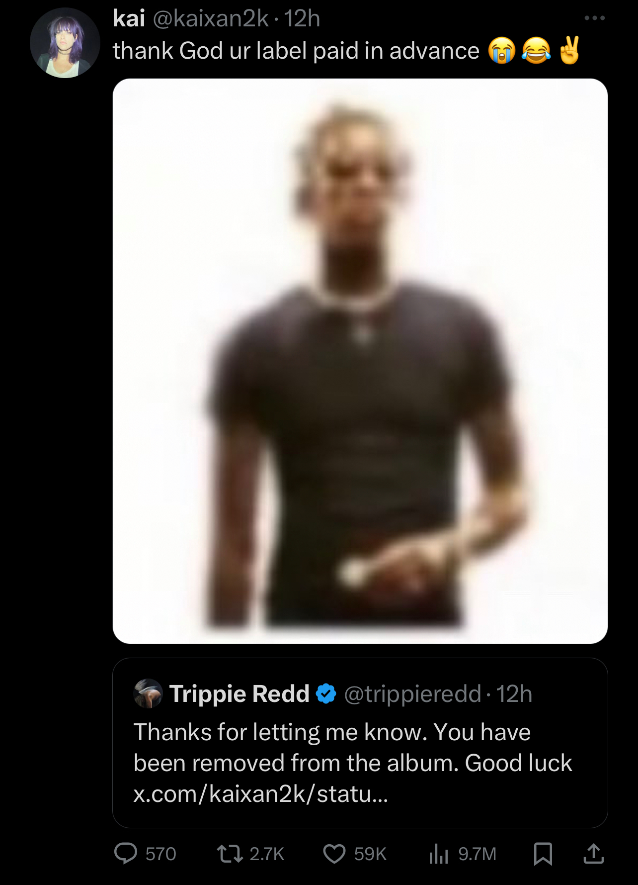 Trippie Redd in a casual black tee, responding to a tweet with a humorous comment