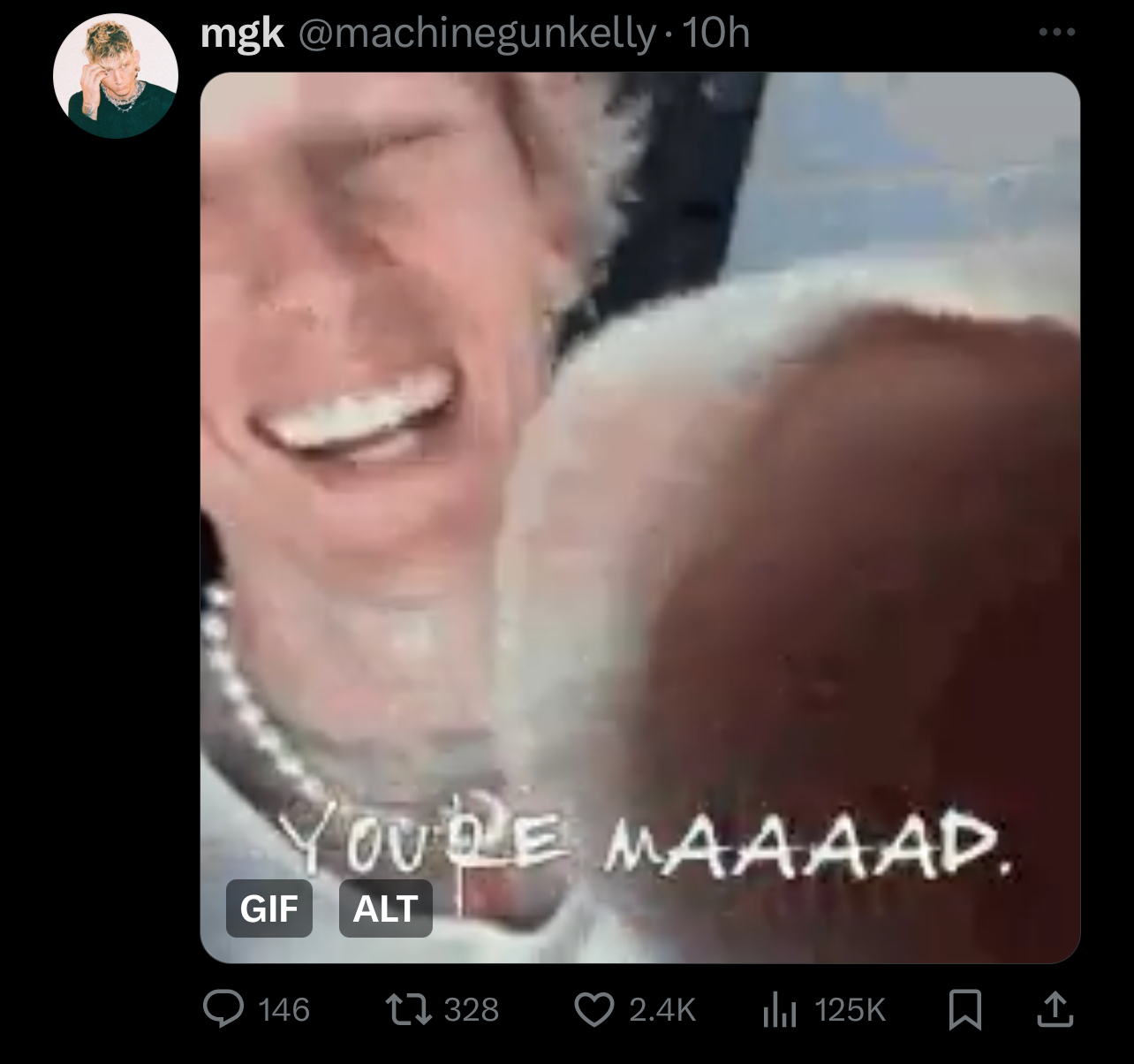 Close-up of Machine Gun Kelly laughing with overlaid text &quot;YOU&#x27;RE MAAAAD.&quot;