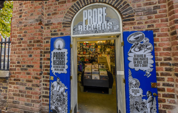 Entrance to Probe Records shop with unique signage and vintage music album displays visible inside