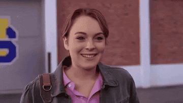 Person smiling and waving at the camera