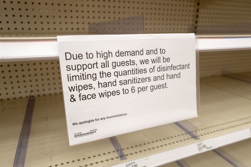 Sign on store shelf limiting disinfectant wipes, hand sanitizers, and face wipes to 6 per guest due to high demand