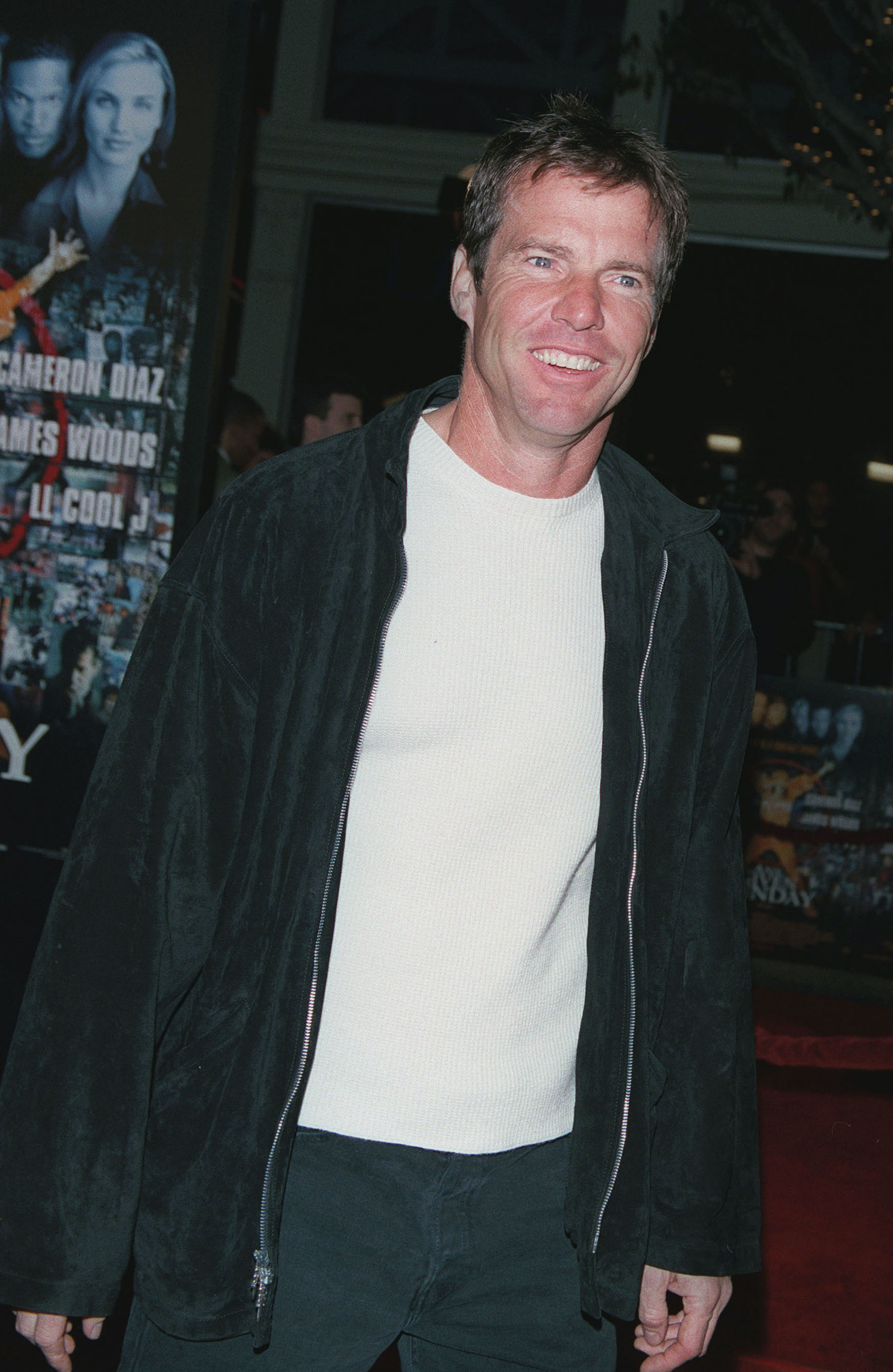 Man in a black jacket over a white shirt at a premiere