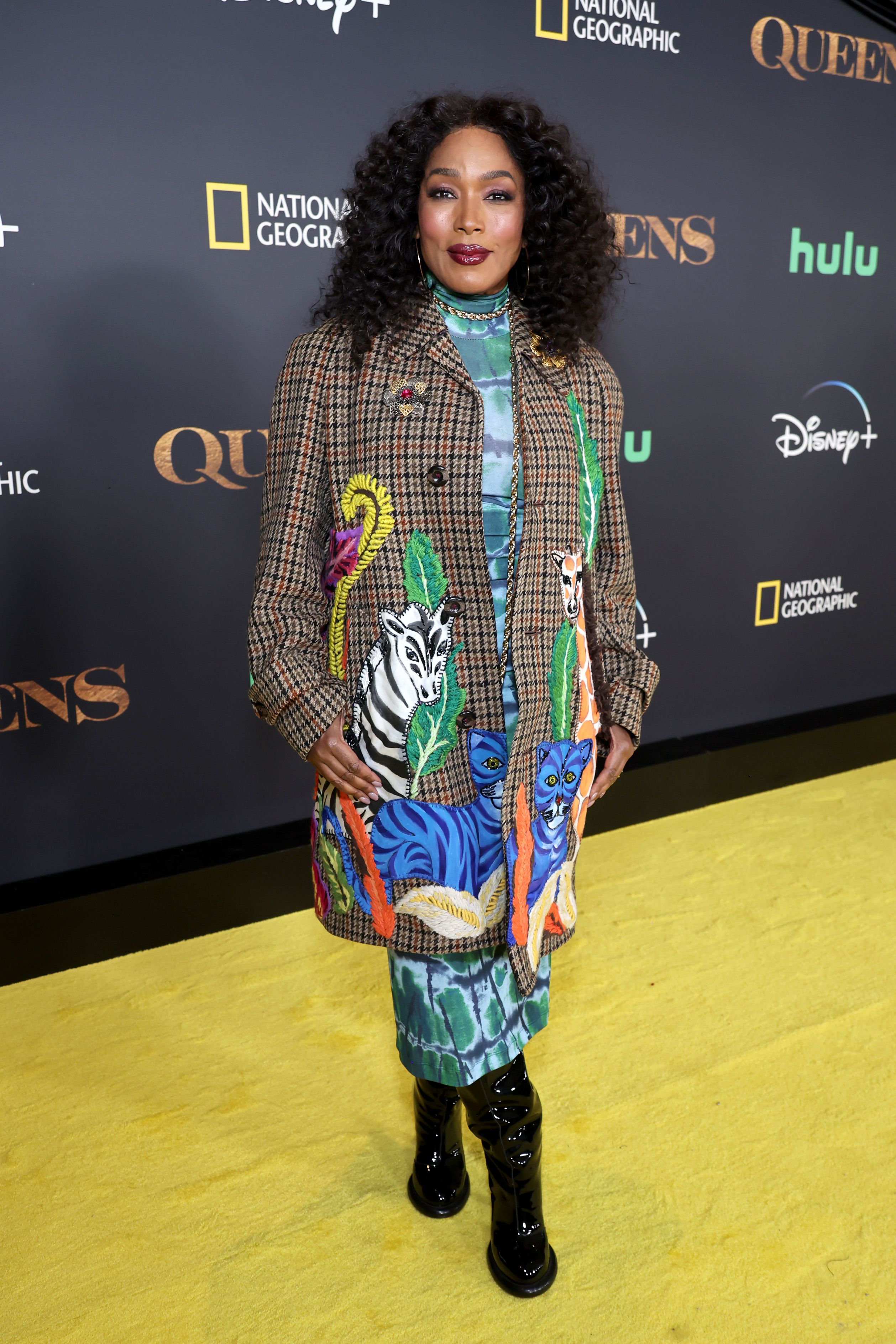 Angela Bassett in a patterned coat and boots at a Queen of Queens event