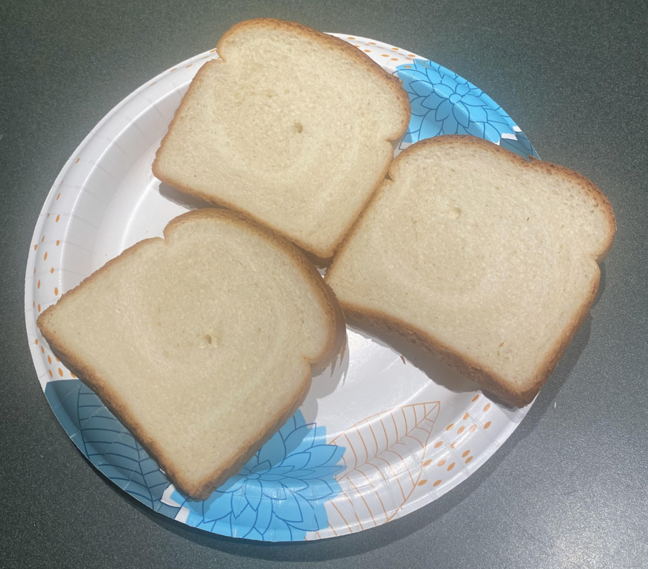 Three slices of white bread on a patterned plate