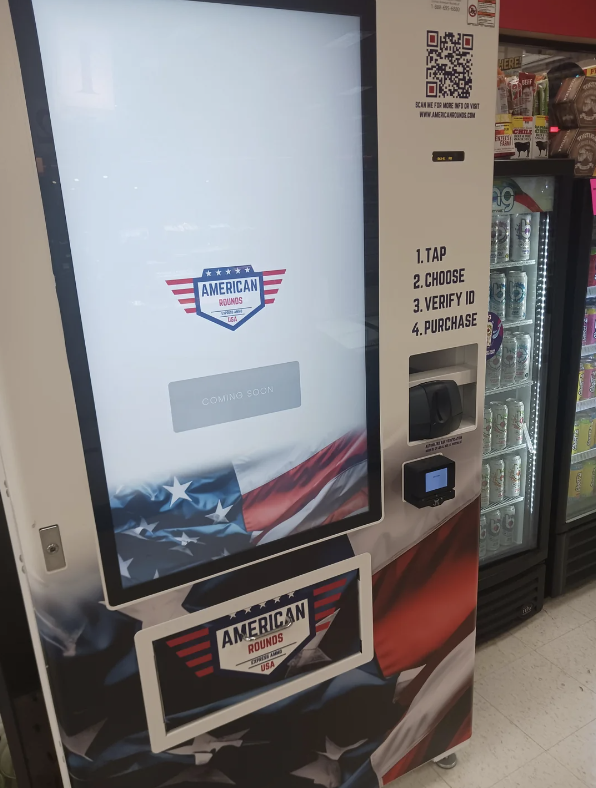 Vending machine with &quot;American Rounds&quot; branding, instructions to tap, verify ID, and purchase, and a draped flag design. Coming soon